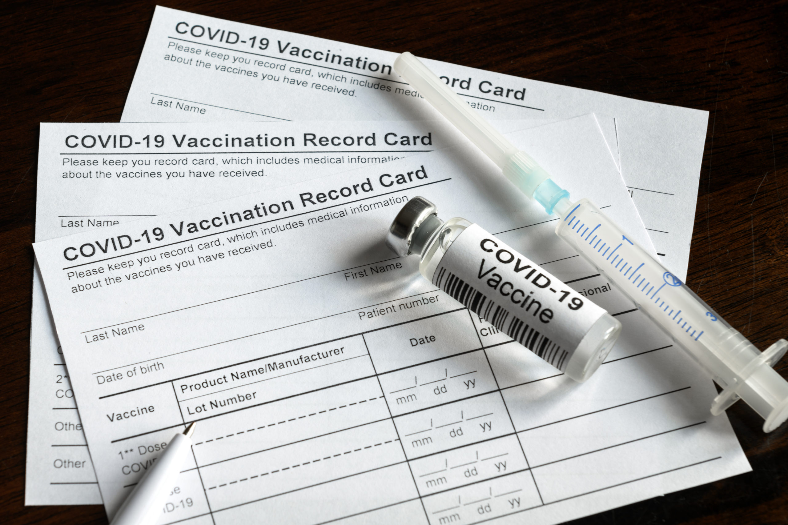 Covid-19,Vaccination,Record,Card,On,Desk,,Coronavirus,Immunization,Certificate,And