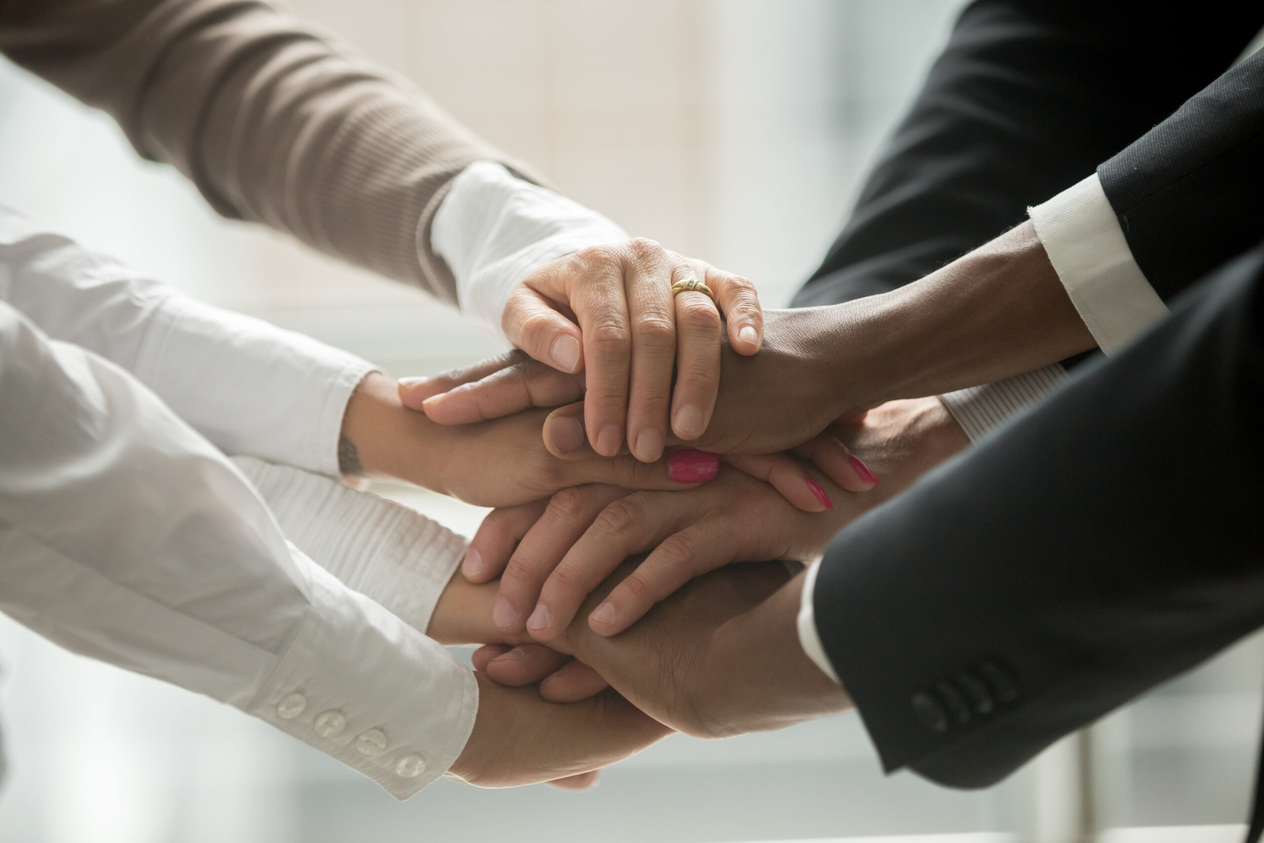 Diverse,People,Putting,Stacked,Hands,Together,Promising,Help,And,Support